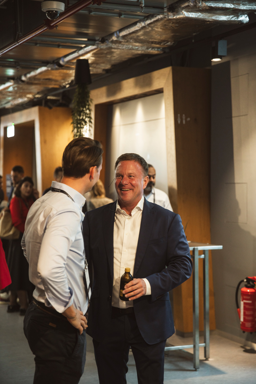 Business professionals engaging in conversation at Temedica’s “The Future of Health Insights” 2024 event, highlighting networking and collaboration in digital healthcare innovation